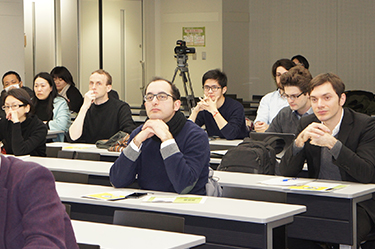 Participants listening intently as the event begins
