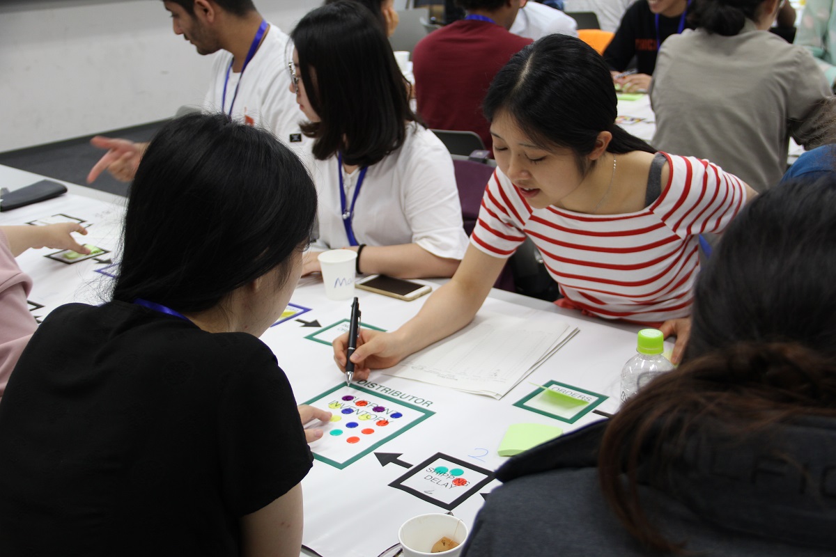 Some students write down scores after a round of the game